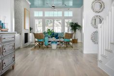 a living room filled with furniture and a ceiling fan