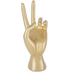 a gold colored statue of a hand making the peace sign