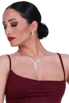 Tango performance jewelry set, White crystal rhinestone earrings, Silver sparkling wedding earrings and necklace, V shape strass necklace Isadora Tango Earrings & Necklace Set Enhance your Tango ensemble with the ideal combination of earrings and a necklace, designed to complement each other seamlessly. This jewelry set is versatile, pairing effortlessly with a wide range of outfits. Adorned with numerous rhinestones, you'll shine both on the dance floor and beyond. Pair with your favorite conDi Wedding Earrings And Necklace, Sparkling Wedding, Earrings Necklace Set, Tango Dress, Deodorant Stains, Earrings And Necklace, On The Dance Floor, Hypoallergenic Earrings, White Crystal