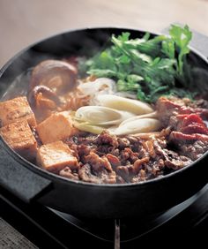 a pan filled with food sitting on top of a stove