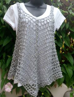 a woman's white shirt with crochet on it