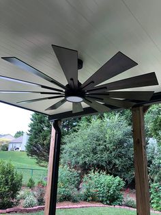 an outdoor patio with a ceiling fan on it