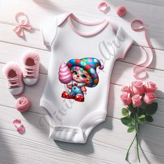 a baby bodysuit with an image of a clown on it next to pink roses