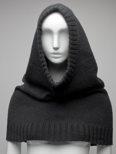 a mannequin head wearing a black hooded sweater