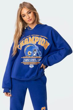 Get the oversized look with this champion graphic hoodie. This cozy drop shoulder sweatshirt is constructed from a soft flock fabric and features ribbed cuffed sleeves to lock in the warmth. Luxury Oversize Hoodie Sweatshirt, Cheap Graphic Print Sweatshirt For Sports Season, Blue Sweatshirt With Text Print, Luxury Trendy Sweatshirt For Streetwear, Sporty Sweatshirt With Custom Print, Cheap Sports Sweatshirt With Screen Print, Luxury Blue Sweatshirt With Logo Detail, Luxury Letter Print Sweatshirt For Streetwear, Luxury Oversized Letter Print Sweatshirt