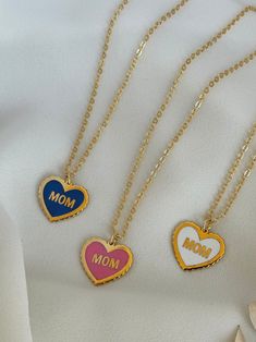 The Word Mom on a heart shape filled with colorful enamel on a beautiful handmade necklace ♥  18k Gold plated  -------------------------- ◦Gift idea suitable for every occasion (Birthday / Anniversary/ Mother's day/ Teacher's day /Christmas) ◦Necklace length 40 cm with 3 cm extra extension ◦Handmade with care and love Product Specifications: ✓Adjustable ✓High quality ✓Handmade ✓Long lasting ✓Unique gift idea All our Products are handmade with care using high quality materials and fine finishing Enamel Heart Pendant Necklace As Gift, Heart Pendant Enamel Necklace For Gift, Heart Pendant Enamel Necklace Gift, Mother's Day Heart Charm Necklace With Clavicle Chain, Mother's Day Heart-shaped Clavicle Chain Charm Necklace, Trendy Gold Plated Charm Necklace For Gift, Trendy Heart-shaped Charm Necklace Gift, Trendy Heart Charm Necklaces For Gift, Trendy Heart-shaped Charm Necklace As Gift