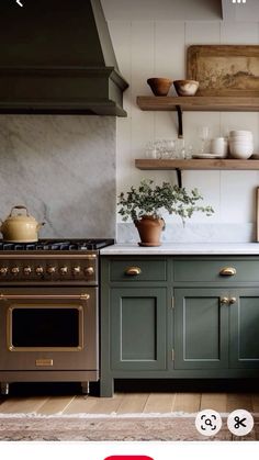 a kitchen with green cabinets and an oven in the center is featured on instagram