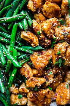 chicken, green beans and sesame seeds on a plate