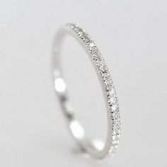 a white gold wedding band with small diamonds on the inside and outside, set in 18k white gold