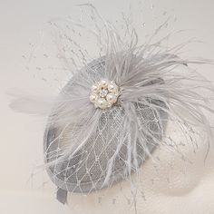 Elegant 1940s  shimmering silver teardrop shape sinnamay  fascinator. Dainty, understated and very easy to wear. Trimmed with delicate netting,  feathers,  silver rhinestone brooch and a sprinkling of rhinestones over one half of the fascinator base. Origanal design, hand made with tender loving care. Comes with all three interchangeable attachment i.e Clip, comb and satin alice band.  Size at the widest part of the base is 13cm. This listing is for just the teardrop fascinator,  the other items Teardrop Fascinator, Wedding Fascinators, Alice Band, Rhinestone Brooches, Silver Rhinestone, Wedding Hair Accessories, Fascinator, Wedding Accessories, Original Design