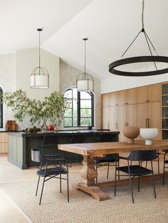 a dining room table and chairs in front of an island