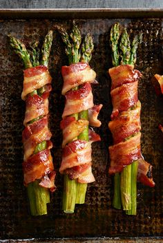 bacon wrapped asparagus on a baking sheet