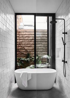 a white bath tub sitting next to a window