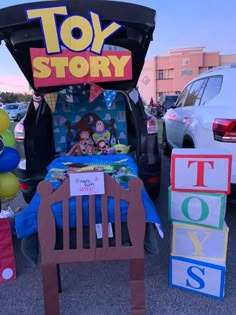 an inflatable toy story car is parked next to other toys and balloons on the ground