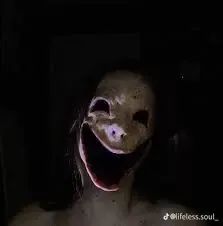 a creepy looking creature with its mouth open in the dark