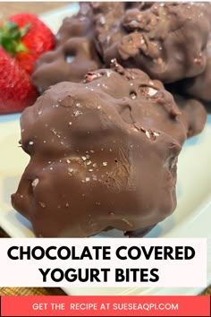 chocolate covered yogurt bites on a white plate with strawberries in the background