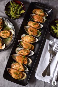 some clams with sauce and green beans on a table