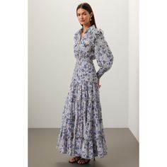 Blue floral chiffon (100% Polyester). A-line. Long sleeves. Collar. Front button closure. 54.5" from shoulder to hemline. Made in the USA of imported fabric. Blue Flowy Feminine Dress, Feminine Blue Dress With Flowy Skirt, Feminine Blue Flowy Dress, Floral Print Flowy Maxi Dress For Daywear, Elegant Billowy Floral Print Maxi Dress, Elegant Flowy Floral Maxi Dress, Blue Elegant Maxi Dress With Smocked Bodice, Elegant Blue Maxi Dress With Smocked Bodice, Classy Clothes