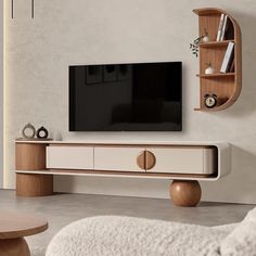 a flat screen tv sitting on top of a wooden entertainment center in a living room