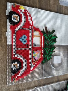 a cross stitch christmas ornament hanging on a wall