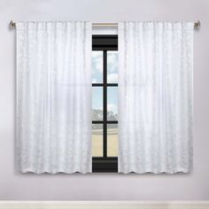 a window with white curtains in front of it and an open window curtain behind it