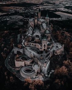 an aerial view of a castle surrounded by trees