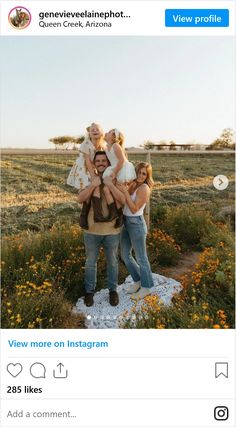 a group of people standing on top of a lush green field next to each other