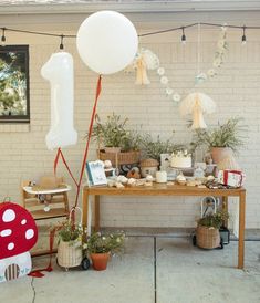 an outdoor birthday party with balloons and decorations