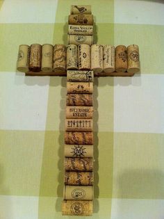 a cross made out of wine corks sitting on top of a table