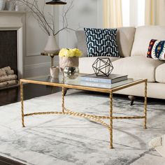 a living room filled with furniture and a fire place next to a white couch in front of a fireplace