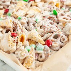 a close up of a tray of food with candy cornflakes and candies