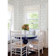 a dining room with blue and white wallpaper