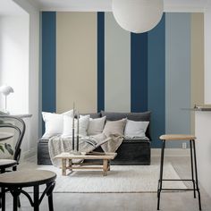 a living room filled with furniture and walls painted in shades of blue, beige and white