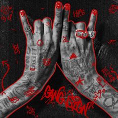 two hands with tattoos and rings on their fingers are shown in front of a black background