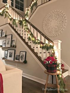 the stairs are decorated with christmas garland and lights