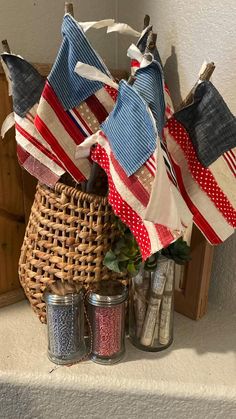 an american flag is hanging on the mantle next to two jars with candles in them