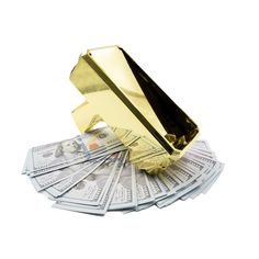 a pile of money sitting on top of a gold object