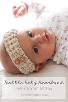 a baby wearing a crochet headband laying on top of a bed