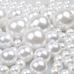 white pearls are arranged in rows on a table