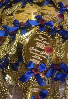 some gold and blue ribbons are on top of the foiled chocolates that have been wrapped in ribbon