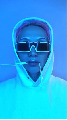 a woman wearing sunglasses and a hoodie in front of a blue background with the words,