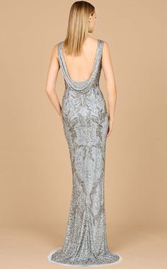 the back of a woman wearing a silver dress with an open back and sequins on