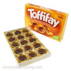 a box of tofffay chocolates next to it's packaging