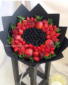 the fruit wreath is made with blackberries, raspberries and peaches