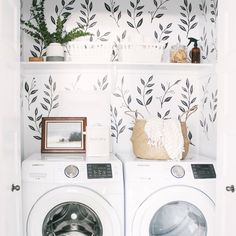 a washer and dryer sitting next to each other in front of a wall