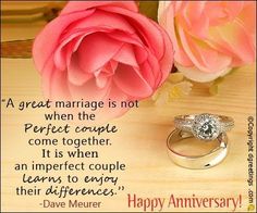 two wedding rings sitting on top of a table next to a pink rose and an anniversary card