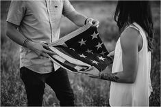 a man and woman holding an american flag