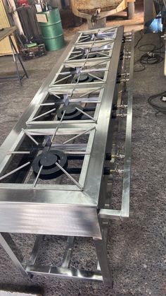 a metal table with four burners on it