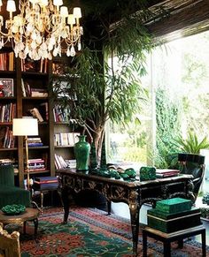 a living room filled with lots of furniture and a chandelier hanging from the ceiling