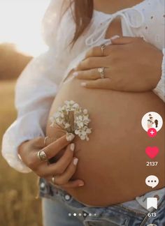 a pregnant woman holding a flower in her belly with the caption that reads, i love you